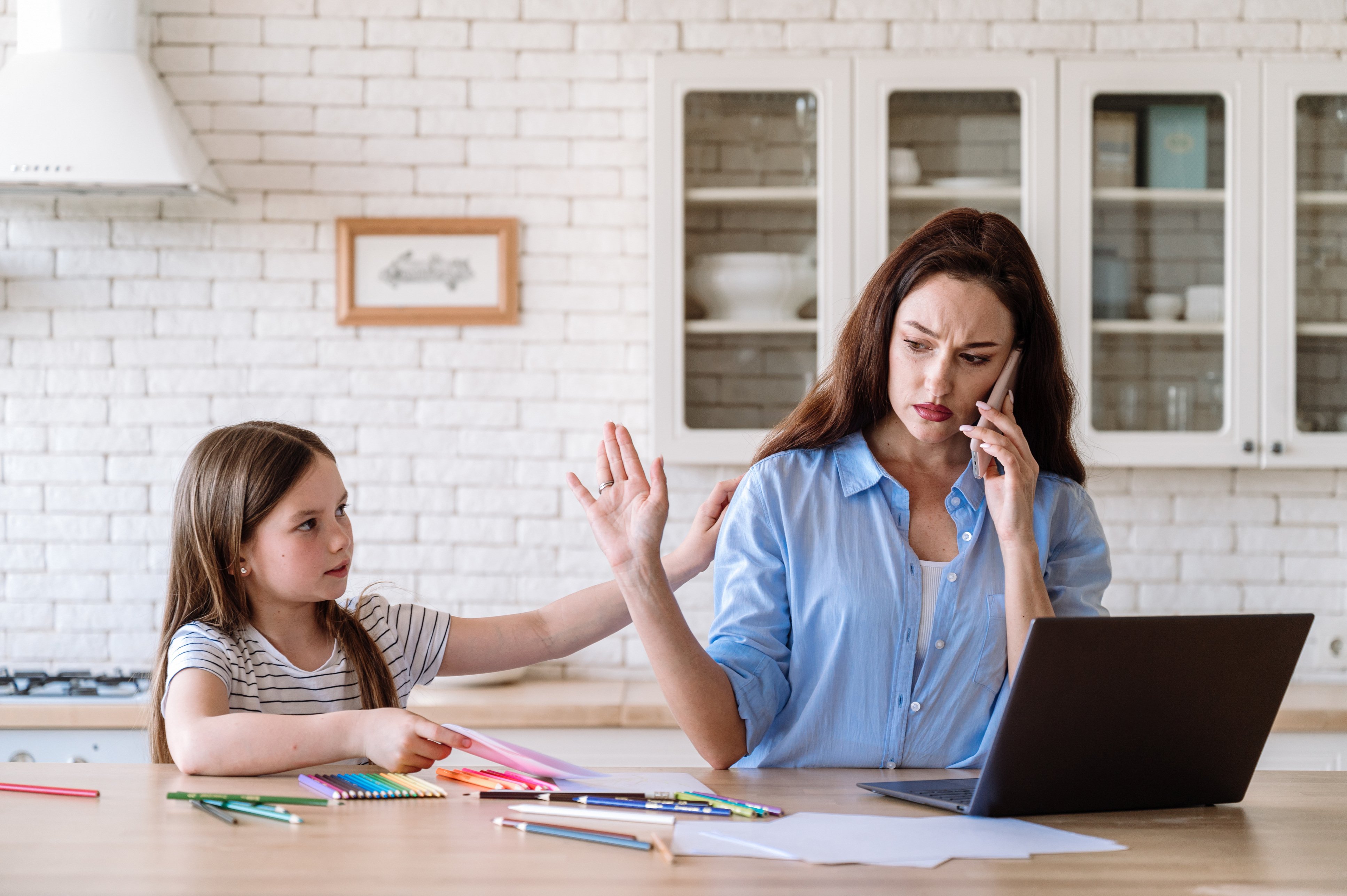 iStock-mom on phone and laptop